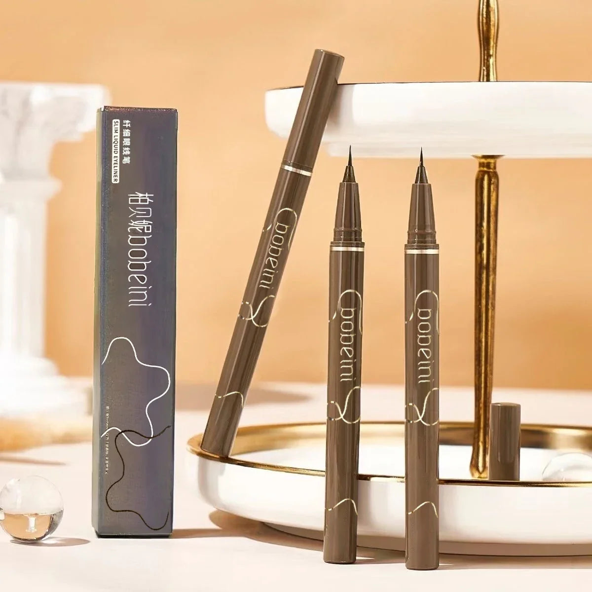 Brown waterproof liquid eyeliner pen by Blushimmer, slim design, long-lasting, sweat-proof, and smudge-resistant for precise application.