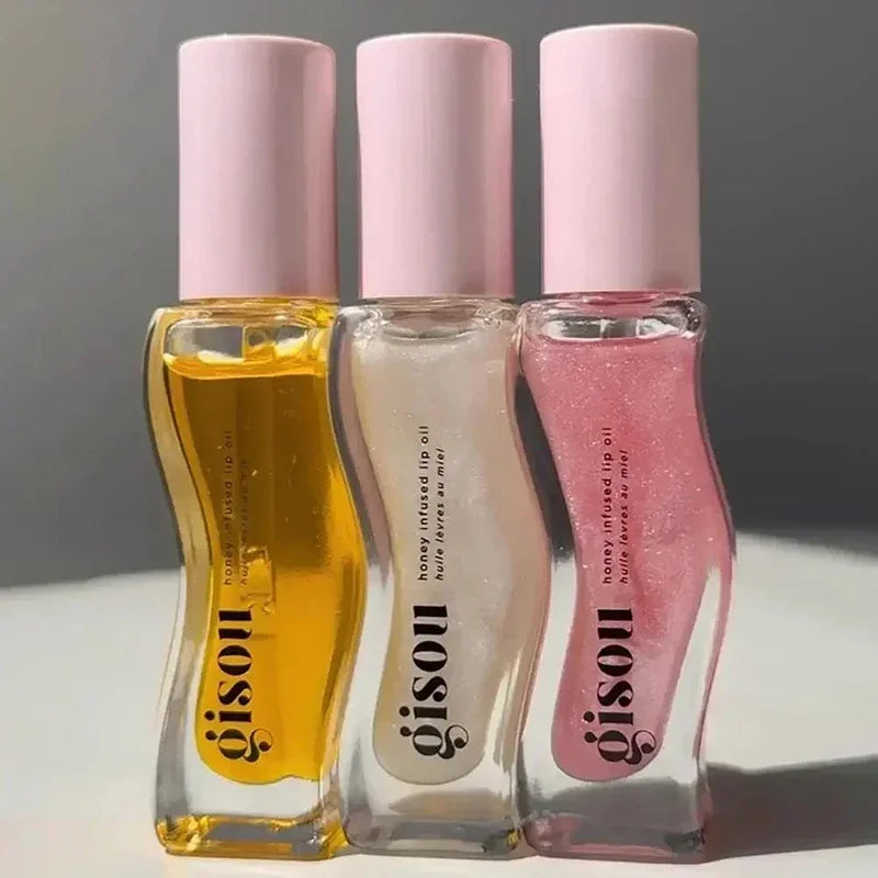 Blushimmer Gisou moisturizing lip balm and lip gloss with plumping and exfoliating benefits, shown in a sleek tube.