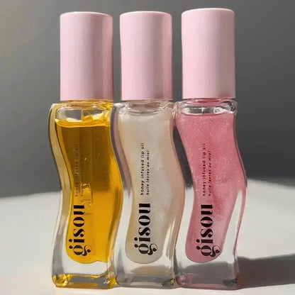 Blushimmer Gisou moisturizing lip balm and lip gloss with plumping and exfoliating benefits, shown in a sleek tube.