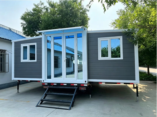 Expandable BACKUPMYFILESNOW® container home with foldable design, shown as a prefabricated mobile house suitable for living or rental.