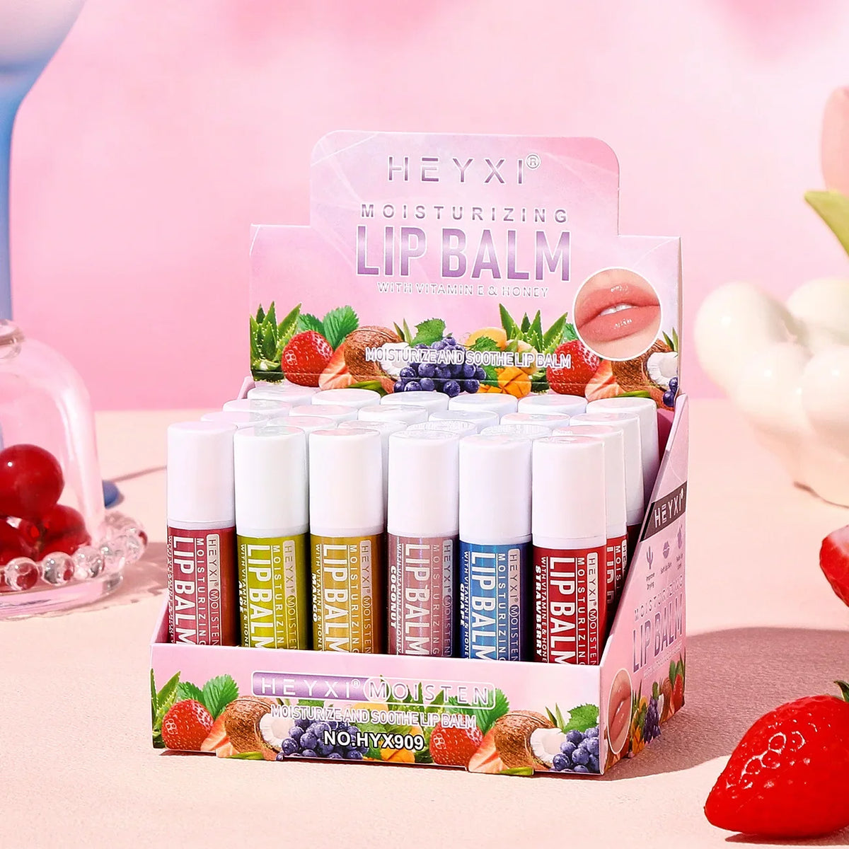 Set of 24 Blushimmer fruit flavored lip balms showing colorful tubes, natural moisturizing and hydrating lip care for winter.