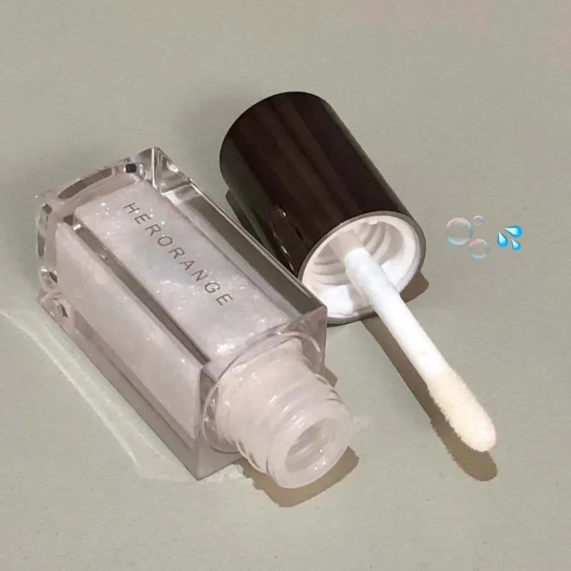 Blue mermaid color pearlescent lip gloss by Blushimmer with diamond sparkle, shiny tint, and waterproof finish for glittery lips.