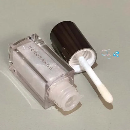 Blue mermaid color pearlescent lip gloss by Blushimmer with diamond sparkle, shiny tint, and waterproof finish for glittery lips.