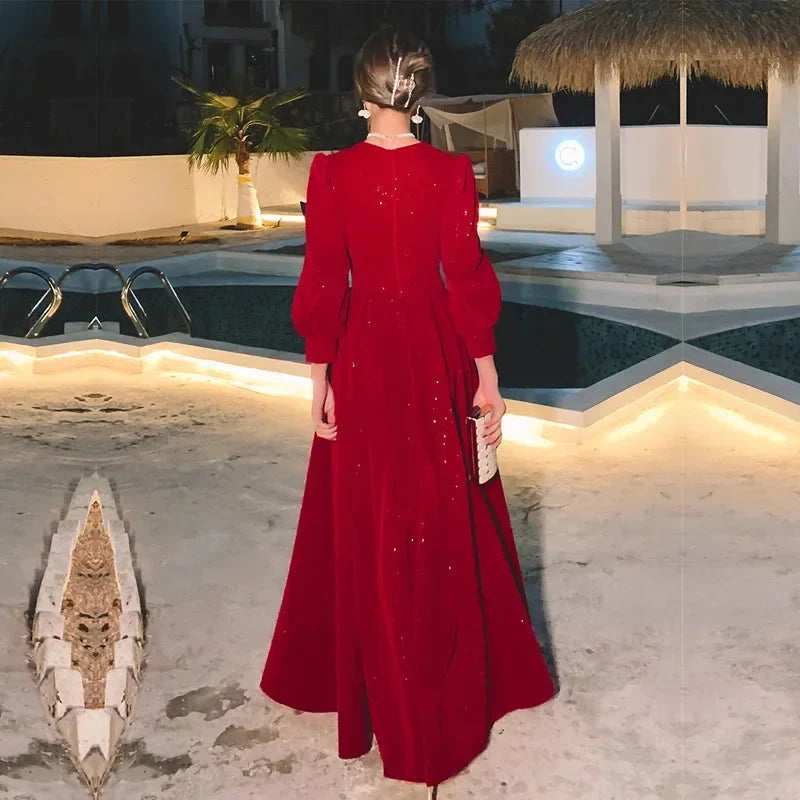 Elegant luxury red ceremony gown by Luxlife Brands, featuring flowing fabric and intricate detailing for formal events.