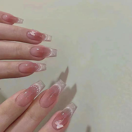 Set of 10 Blushimmer handmade butterfly-shaped eye blush fake nails featuring phototherapy-inspired pink and blush tones.