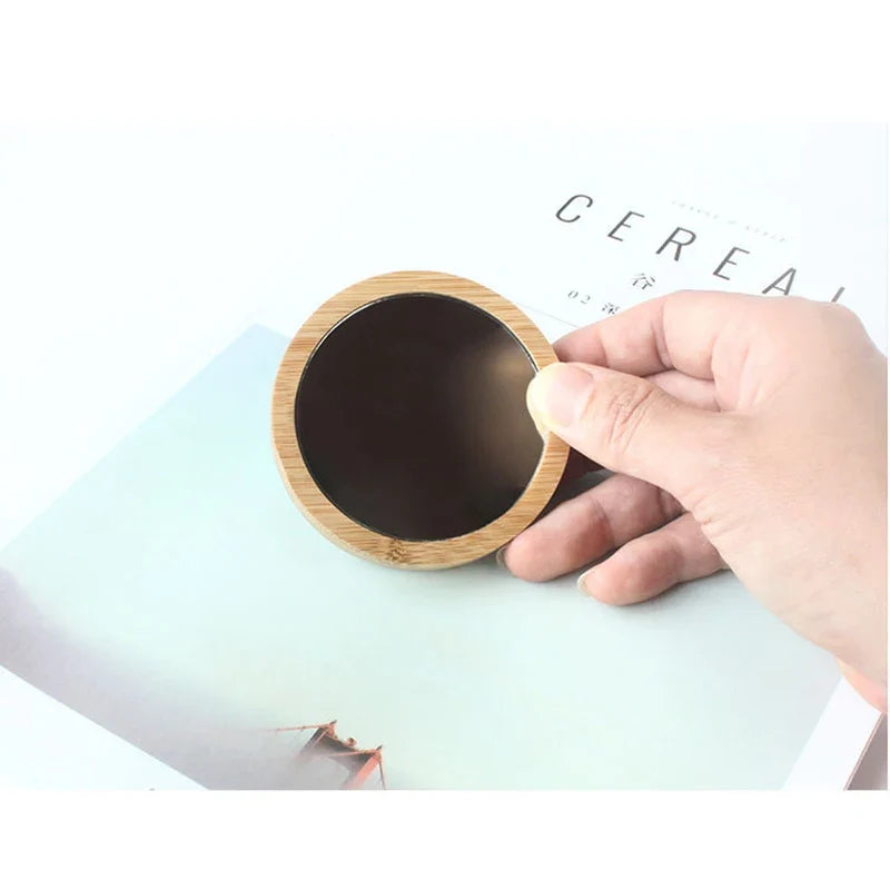 Blushimmer portable round wooden cosmetic mirror, pocket-sized travel compact for beauty and makeup touch-ups.