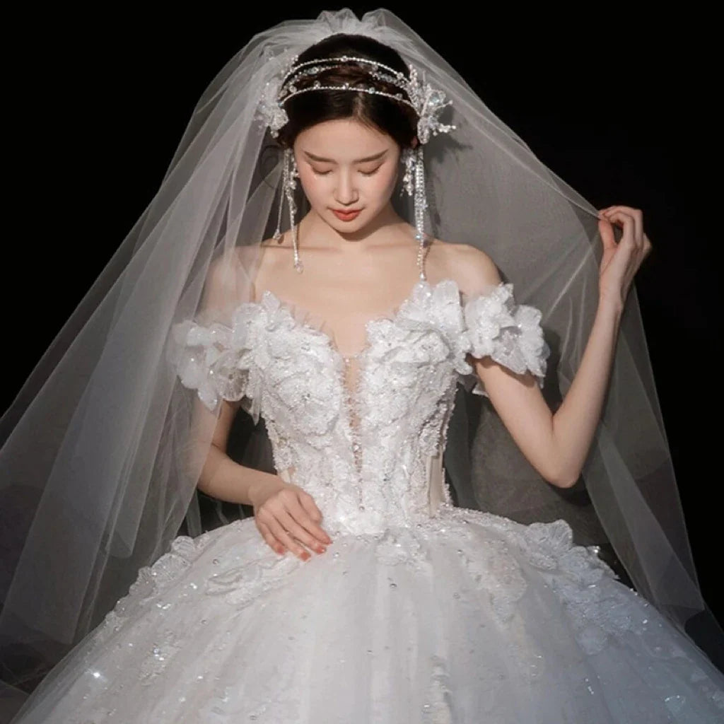 Luxurious wedding dress with shiny appliqué and sweetheart neckline from EdleessFashion, showcasing intricate detailing and elegant design.