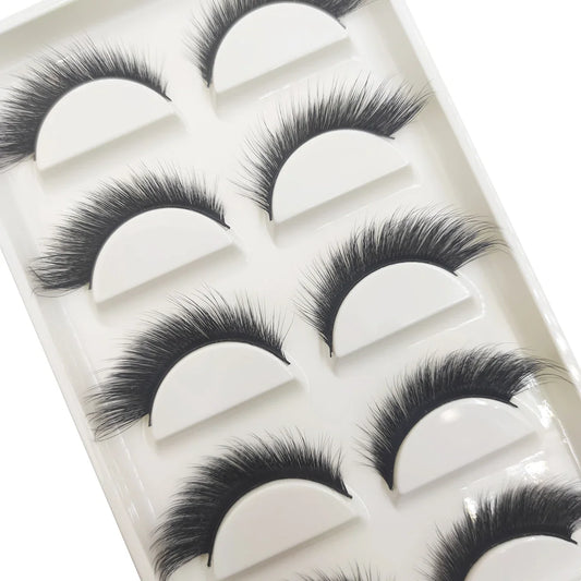 Close-up of Blushimmer 5/7 pairs soft natural 3D mink false eyelashes with elongated cat eye winged style, makeup beauty tools.