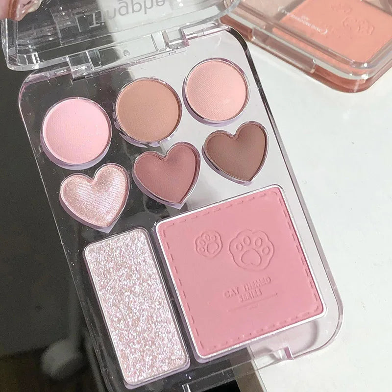 Heart-shaped eyeshadow palette with 8 pink, orange, and highlighter shades from Blushimmer, ideal for brightening and makeup looks.