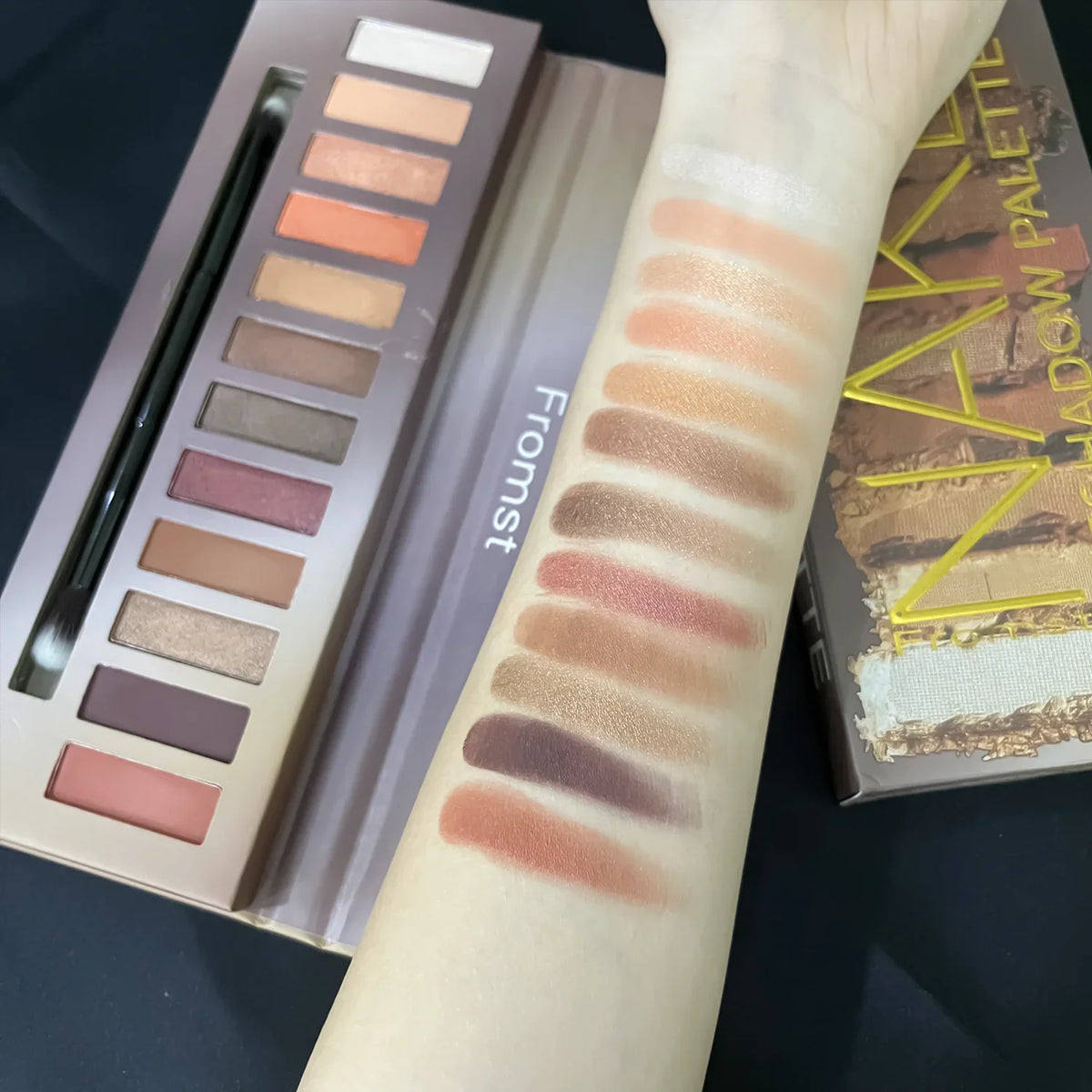 Blushimmer 12-color eyeshadow palette with pearlescent shimmer, waterproof formula, featuring a variety of neutral and vibrant shades.