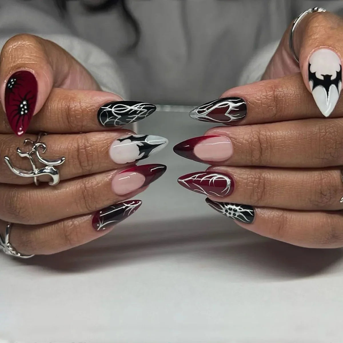 Set of 24 Blushimmer wine red almond press-on nails featuring cartoon rabbit, bowknot, plaid, pearl accents, and French manicure style.