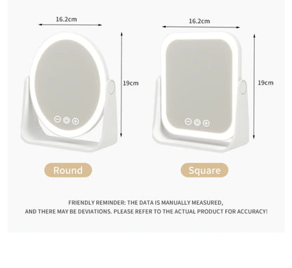 Blushimmer LED makeup mirror with touch dimming, 3x magnifier, portable rechargeable vanity mirror on a desk.