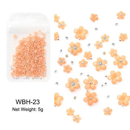 White acrylic flower nail art decorations with mixed size red and blue rhinestones for manicure DIY tools and nail design accessories.