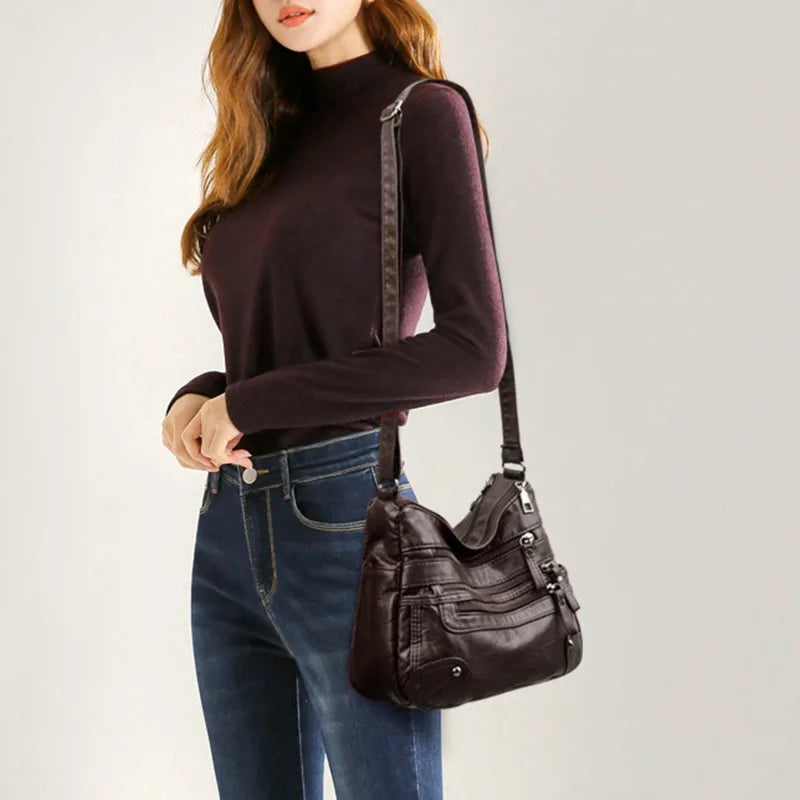 OBA women's multi-layer dark brown leather shoulder crossbody bag with multiple compartments and adjustable strap.