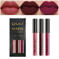 Set of four waterproof liquid lipsticks in black, blue, purple, and green from Blushimmer with matte and nude lip tint finishes.