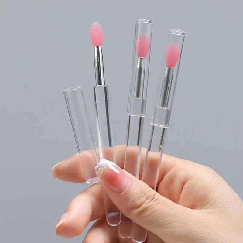 Blushimmer silicone lip and eyeshadow brush with cover, dustproof portable multi-purpose makeup brush with glitter finish.