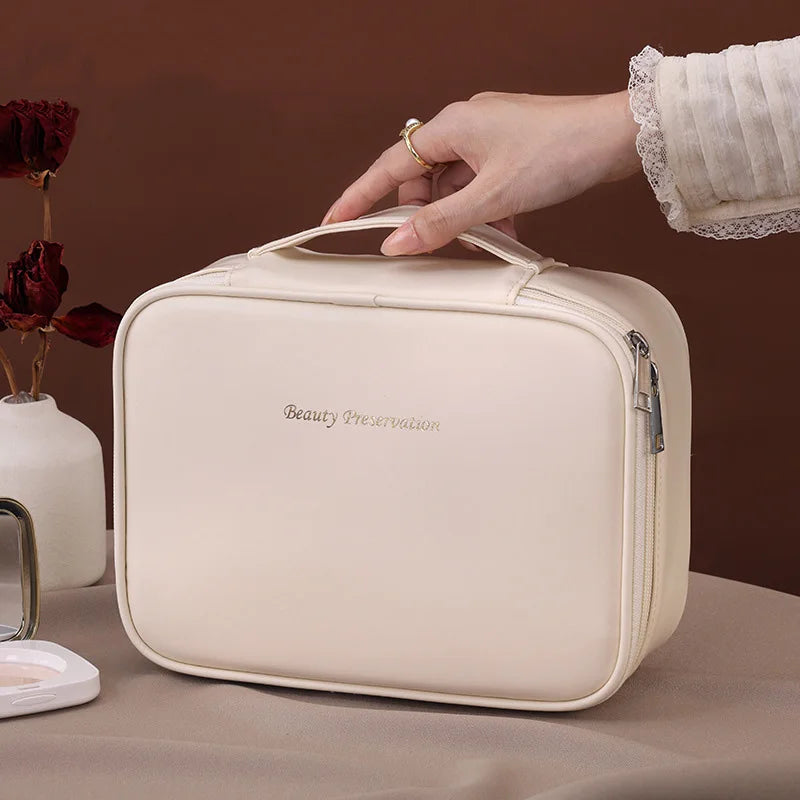 Blushimmer wholesale PU large capacity tote makeup bag with double layer compartments for travel and cosmetic storage.