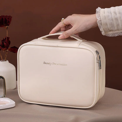 Blushimmer wholesale PU large capacity tote makeup bag with double layer compartments for travel and cosmetic storage.