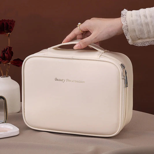 Blushimmer wholesale PU large capacity tote makeup bag with double layer compartments for travel and cosmetic storage.