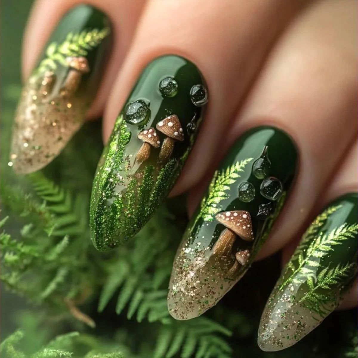 Set of 24 glossy almond false nails by Blushimmer with dark green forest mushroom pattern, gold sequins, and French style design.