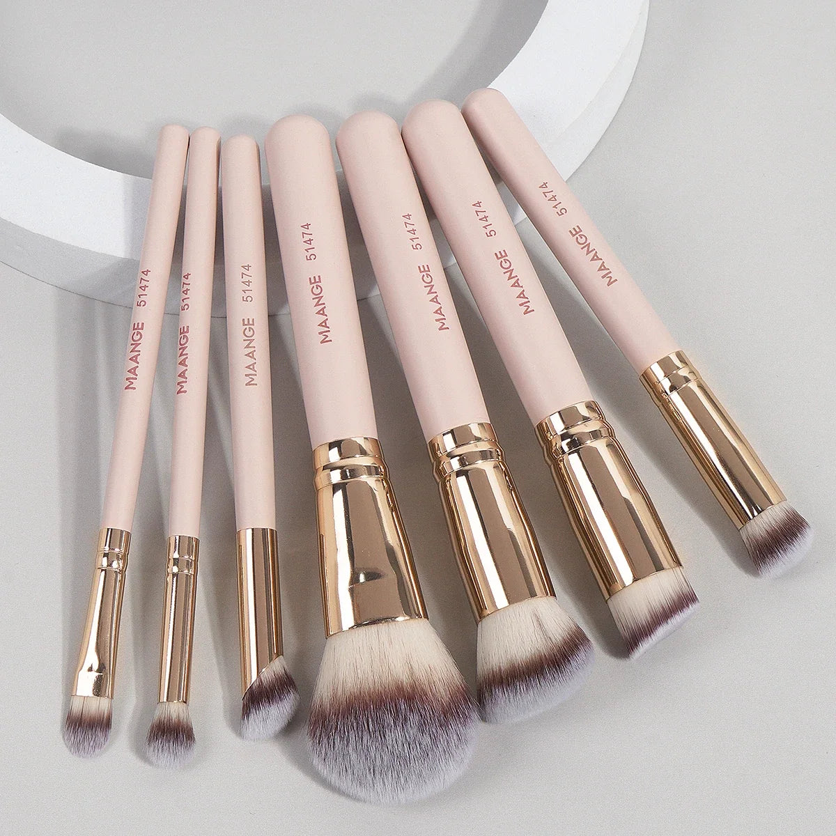 Set of seven Blushimmer makeup brushes with soft bristles for foundation, powder, concealer, and blush application.