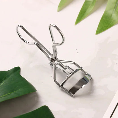 Blushimmer stainless steel eyelash curler with black handle and tweezer tips for precise eyelash curling and cosmetic beauty application.