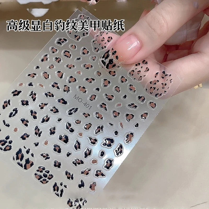 Pink leopard print nail art stickers by Blushimmer, 8x10cm, featuring pink, black, and brown leopard decal designs for DIY manicures.