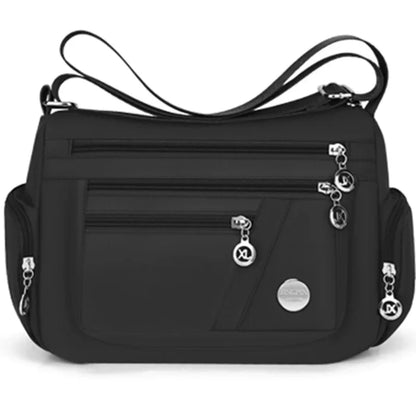 Black OBA ladies crossbody travel handbag with adjustable strap and spacious interior, ideal for everyday use or travel.