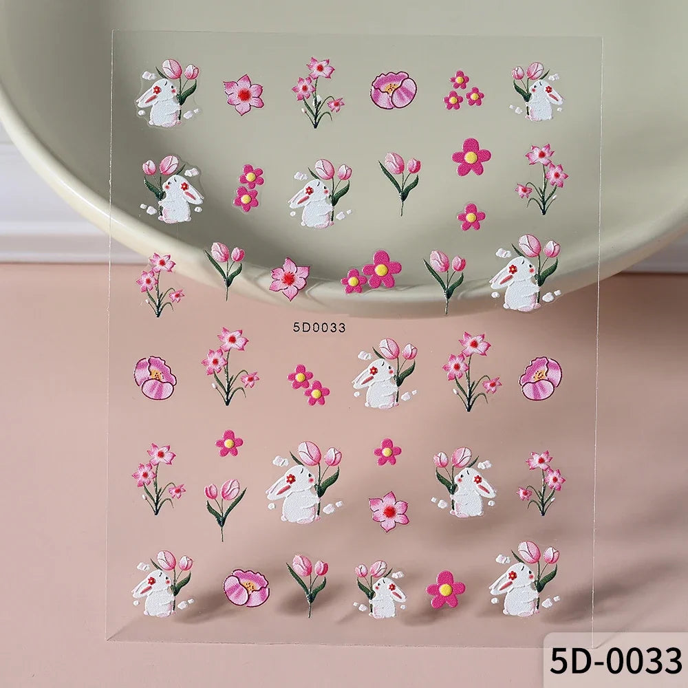 Close-up of Blushimmer 5D panda, rabbit, flower, and animal nail stickers on a nail art decal sheet for Y2K manicure decoration.