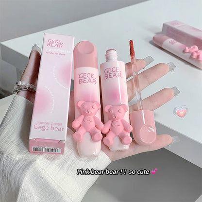 Blushimmer cute bear-shaped lip glaze and matte lipstick in a soft pink shade, held in hand showing smooth, colorful lips