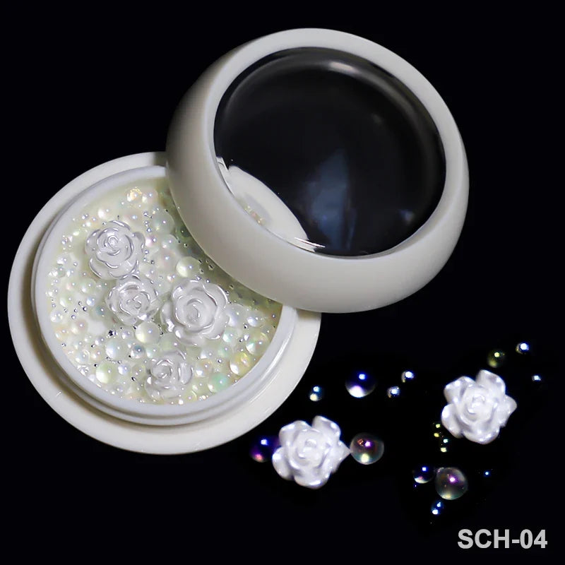White acrylic flower nail art decorations with mixed size rhinestones and colorful gems for manicure designs by Blushimmer.