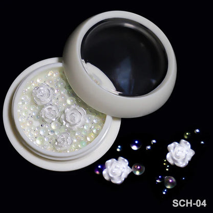 White acrylic flower nail art decorations with mixed size rhinestones and colorful gems for manicure designs by Blushimmer.