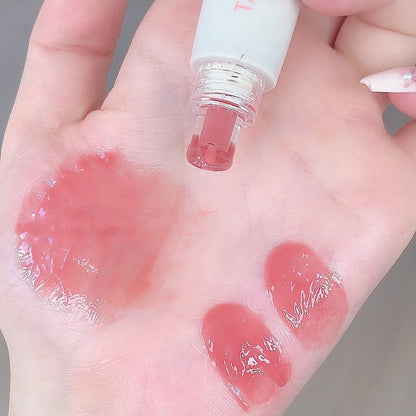 Blushimmer Tatibeauty Lip Jelly Essence Tender Pink hydrating lip gloss with shiny, smooth finish in a clear container.