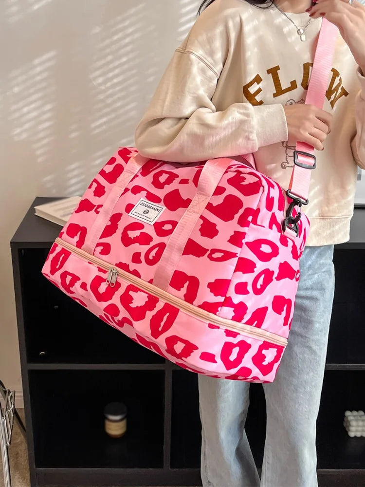 Pink women's OBA carry-on travel bag with sturdy handles and spacious interior, ideal for gym and weekend trips.