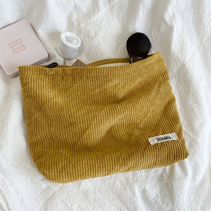 Blushimmer corduroy makeup bag for women, large capacity lipstick, mobile phone, and change holder, handheld style with stylish design.