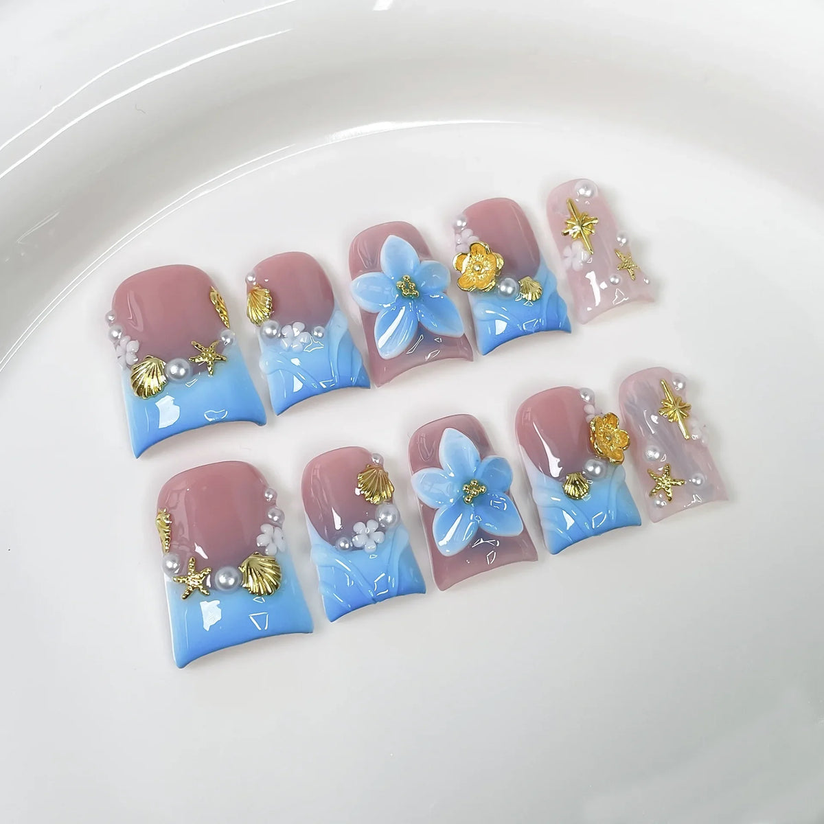 Set of 10 Blushimmer ocean style fake press-on nails with 3D flowers, pearls, gradient blush, and French tip design