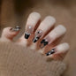 Dark wind gradient long white bow nail patch set by Blushimmer, 24-piece box with stylish fake nails for elegant manicures.