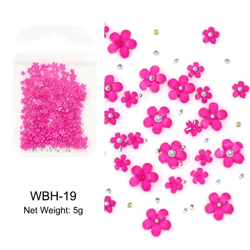 White acrylic flower nail art decorations with mixed size rhinestones and gems for DIY manicure designs.