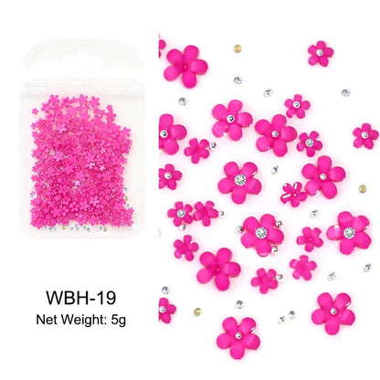 White acrylic flower nail art decorations with mixed size rhinestones and gems for DIY manicure designs.