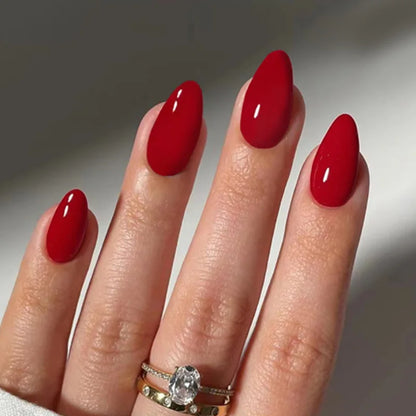 Set of 24 glossy red cat's eye press on nails by Blushimmer, full cover almond-shaped false nails with a nude color finish.