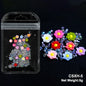 White acrylic flower nail art decorations with mixed size rhinestones and colored gems for DIY manicure embellishments.