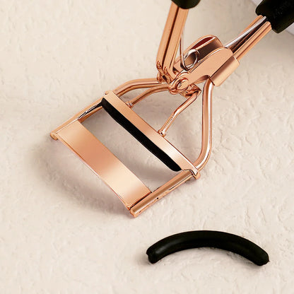 Blushimmer portable eyelash curler with stainless steel body and 15 silicone pads, designed for eyelash extension and curling.