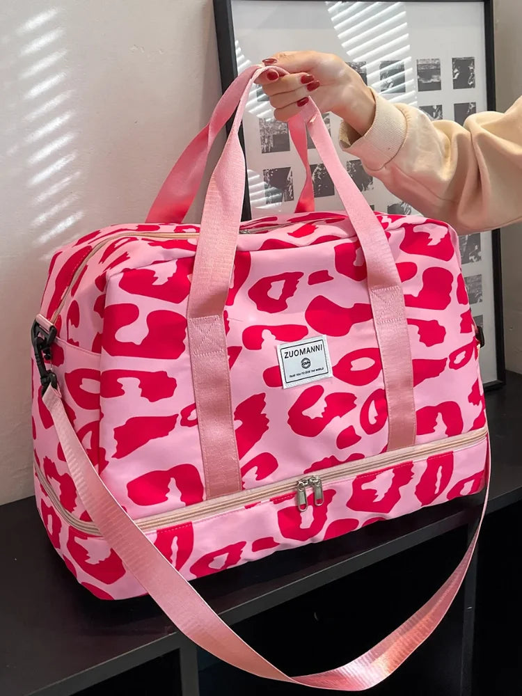 Pink women's carry-on travel bag by OBA, gym duffel style with sturdy handles and spacious main compartment for travel essentials.