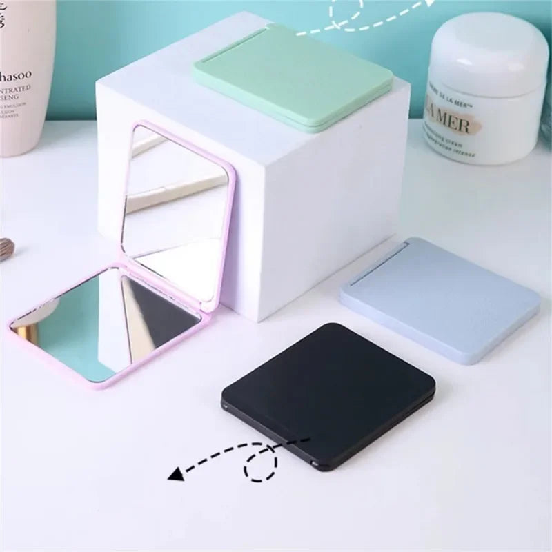 Blushimmer foldable double-sided makeup mirror, portable and compact for dorm or travel use, with a sleek design.