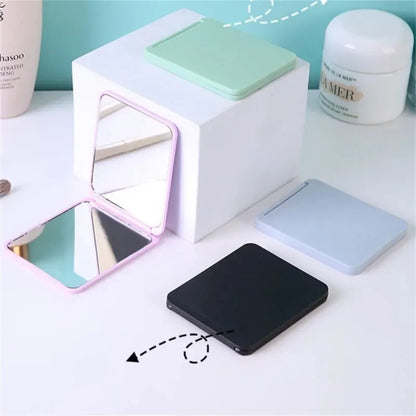 Blushimmer foldable double-sided makeup mirror, portable and compact for dorm or travel use, with a sleek design.