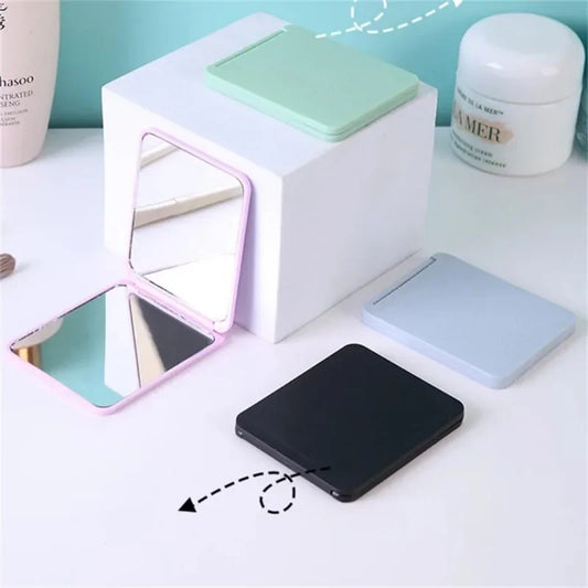 Blushimmer foldable double-sided makeup mirror, portable and compact for dorm or travel use, with a sleek design.