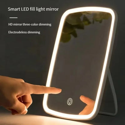 Blushimmer LED makeup mirror with stand, folding compact square design, portable lighted vanity mirror with touch screen for tabletop use.