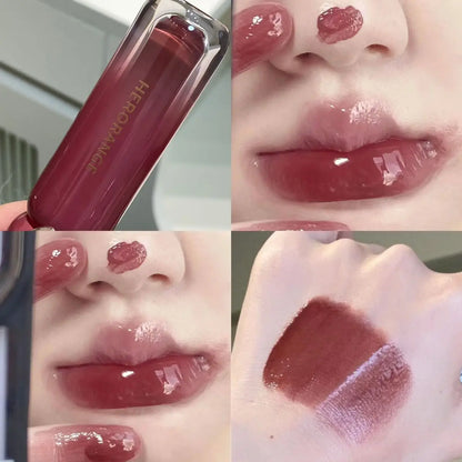 Blushimmer smoked grape purple red lip gloss with moisturizing liquid lipstick and clear tint, reflecting in a mirror.