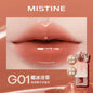 Blushimmer Mistine Nude Long Wear Lipstick in creamy matte finish, showing a sleek 2.9g tube with glossy lip glaze in a mirror.