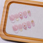 Set of 10 Blushimmer French almond press-on nails with floral design, wearable false nails for easy application and natural look.